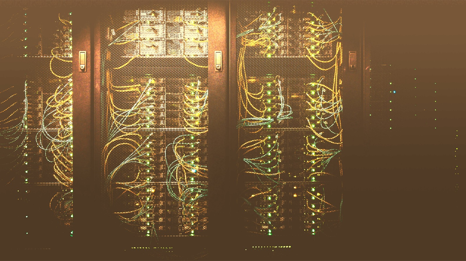 Server racks with amber fibre cabling in a data centre